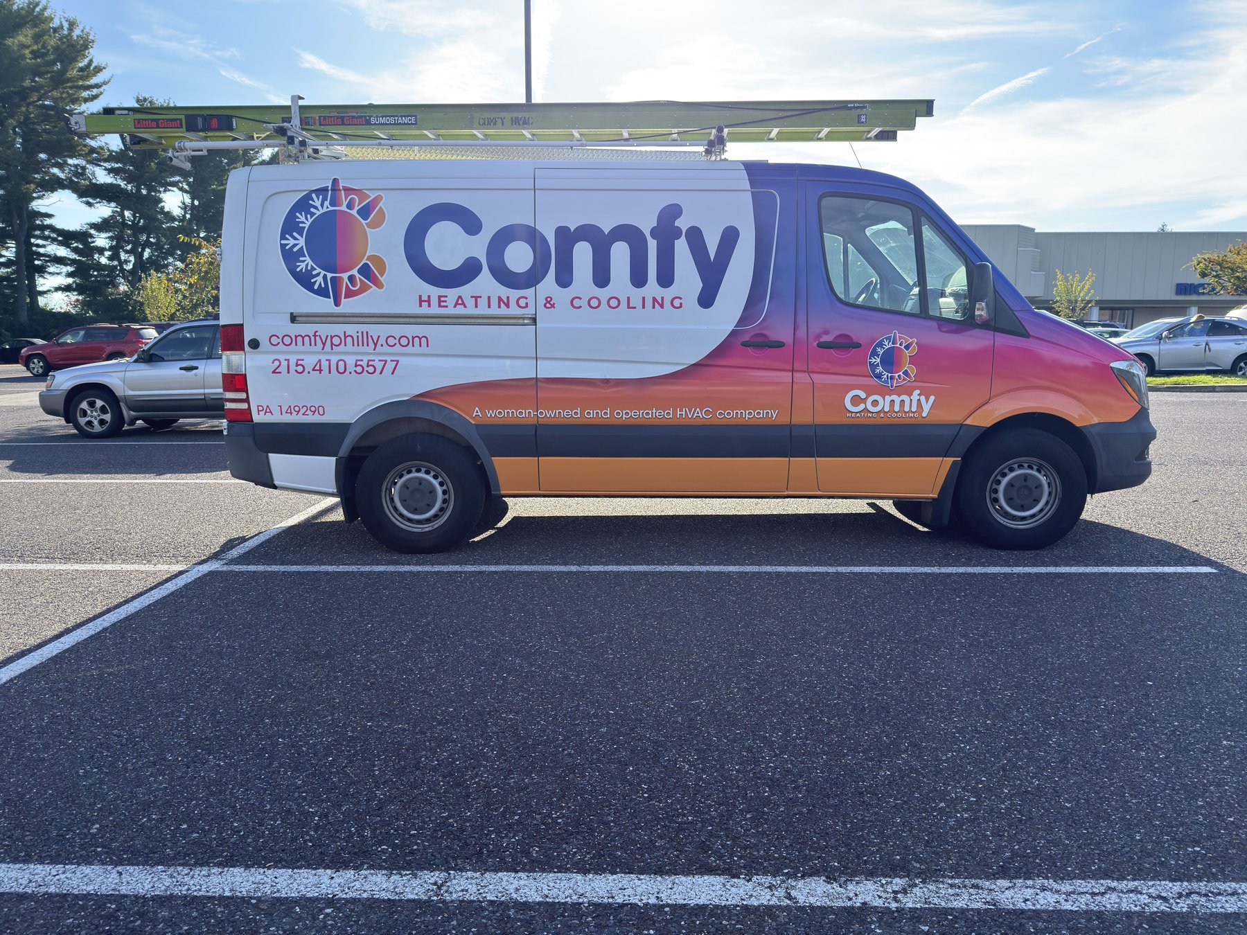 Comfy Heating & Cooling van with its blue, pink, and orange wrap