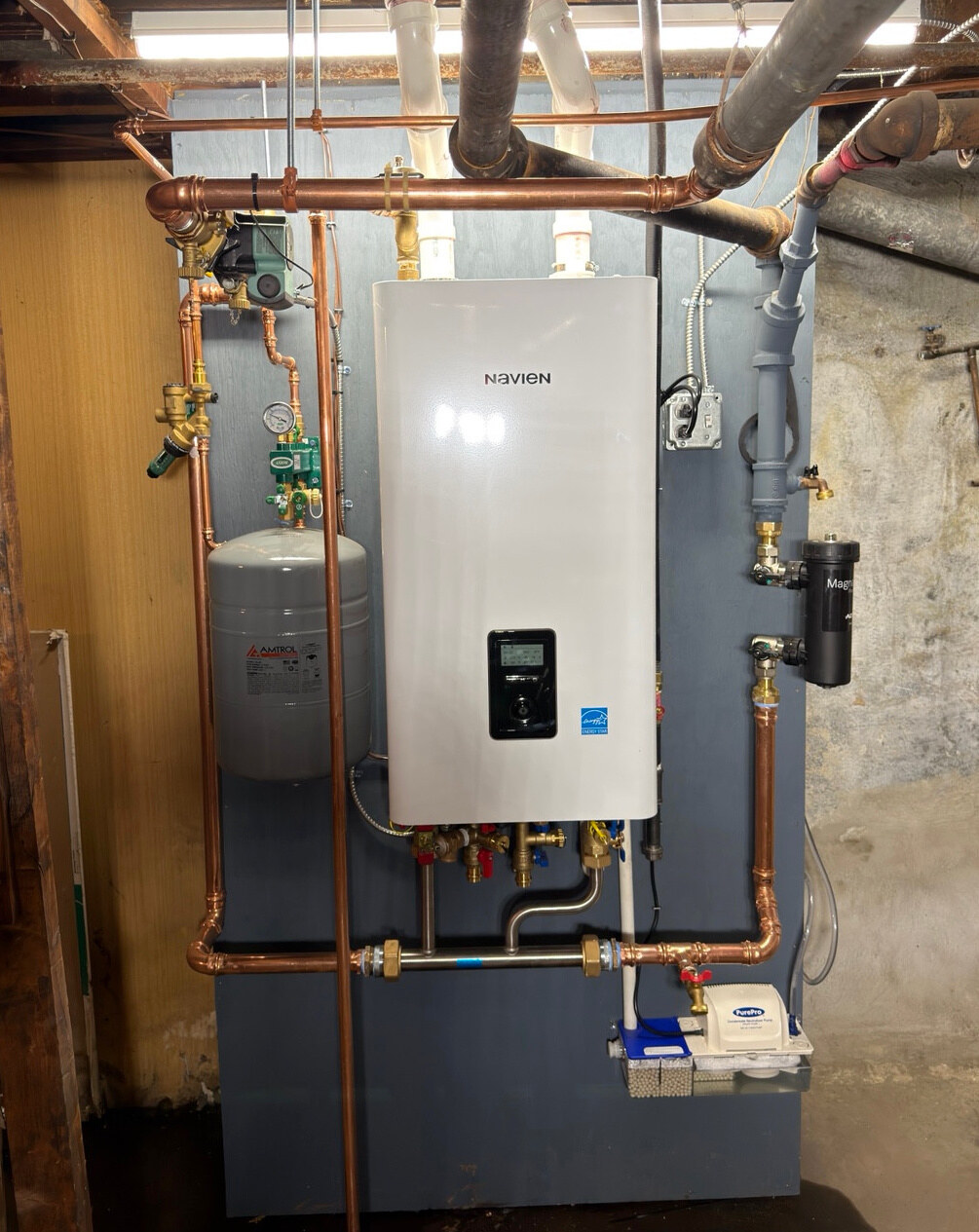 Navien boiler installed by Comfy Heating & Cooling, with expansion tank, copper piping, magnetic filter and condensate pump